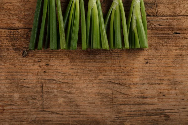 Onion sticks on wooden table — Stock Photo, Image