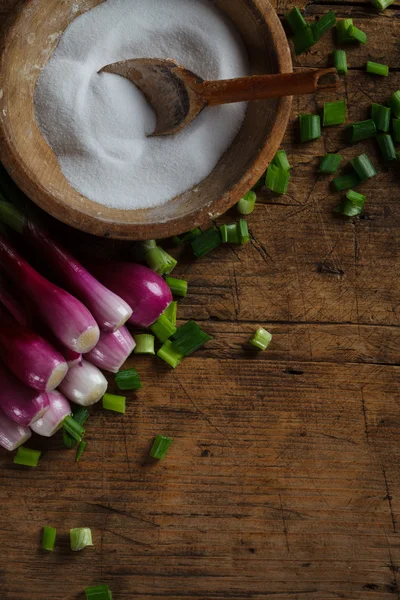 Onions near salt box Stock Image