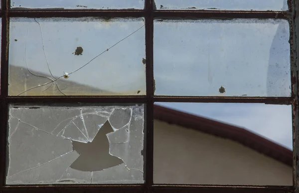 broken glass in the window. background sky, danger, devastation