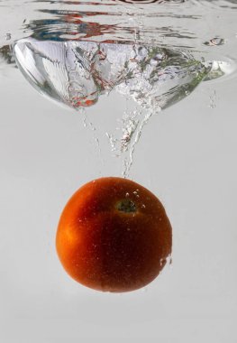 Olgun domates büyük bir su sıçramasıyla derin sulara düşer..