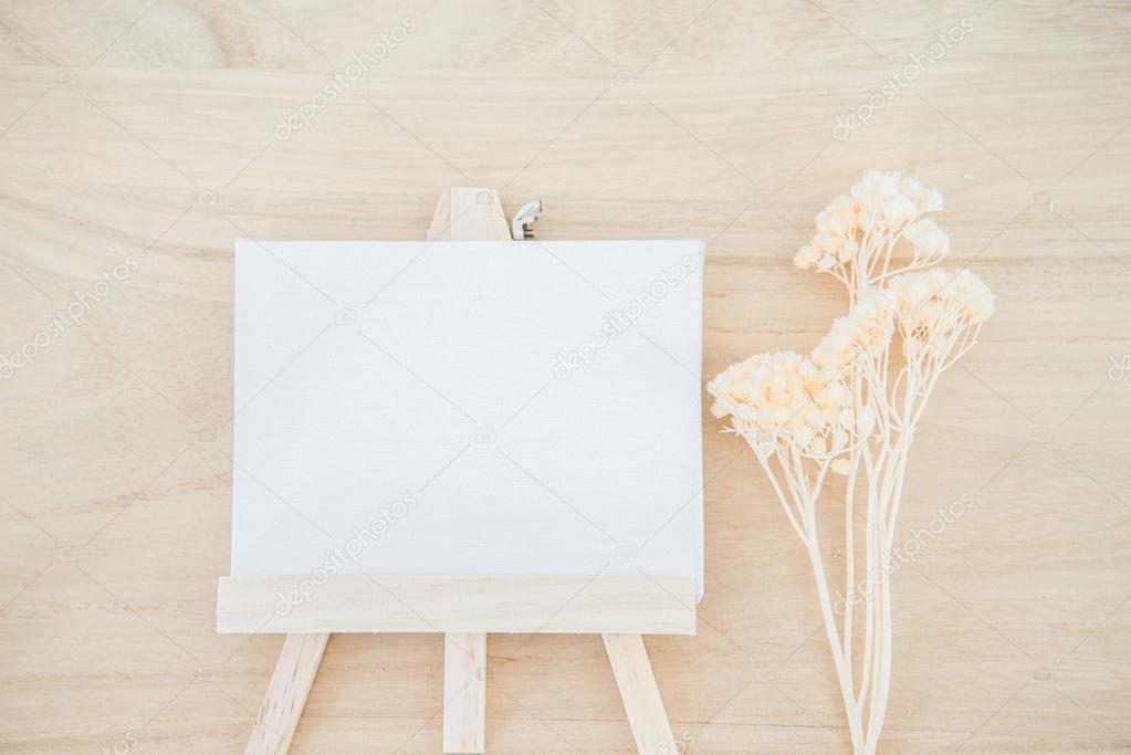 White canvas art board on wood texture background