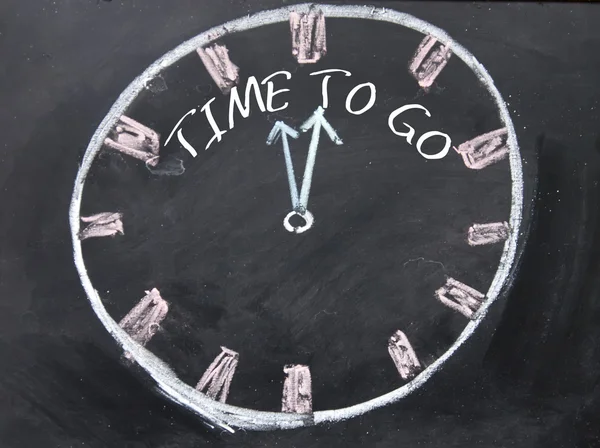 Time to go text and hourglass sign on blackboard — Stock Photo, Image