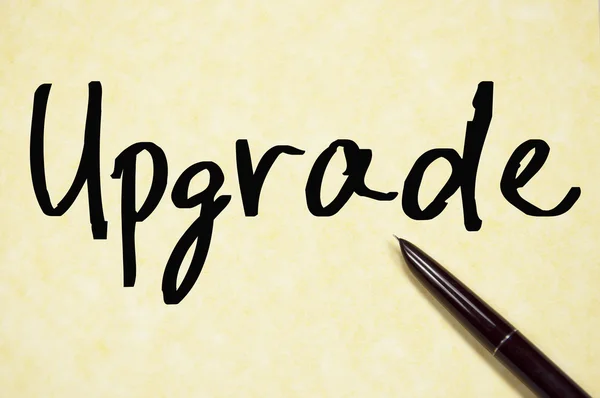 Upgrade woord schrijven op papier — Stockfoto