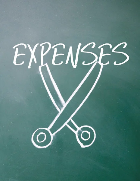 Abstract scissors cut expenses symbol on blackboard — Stock Photo, Image