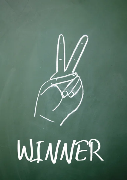 Winner gesture on blackboard — Stock Photo, Image