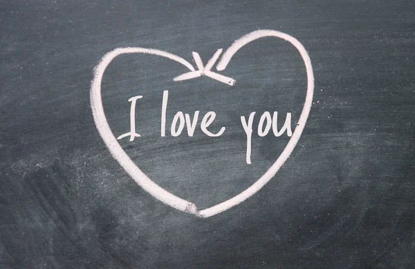 I love you text and heart sign on blackboard — Stock Photo, Image