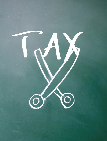 Scissors cut tax sign on blackboard — Stock Photo, Image