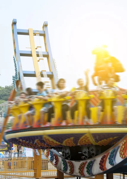 Soaring across the skies in amusement park — Stock Photo, Image