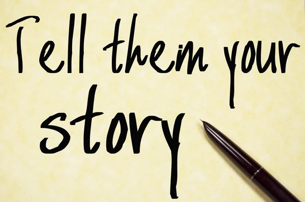 Erzählen Sie ihnen Ihre Geschichte Text schreiben auf Papier lizenzfreie Stockfotos