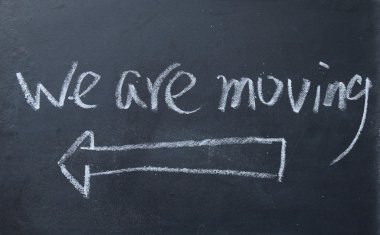 we are moving sign on blackboard clipart