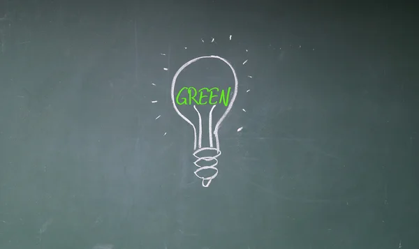 Green bulb sign on blackboard — Stock Photo, Image