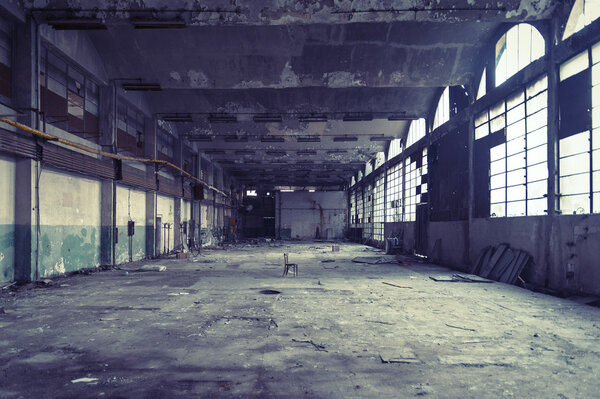 Old abandoned shoe factory at sundown.