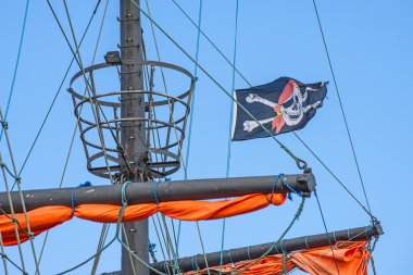 Pirate flag on a historic ship clipart