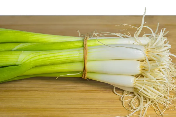 Spring onion on a plank — Stock Photo, Image