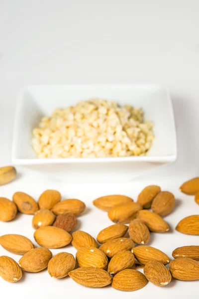 Almonds, whole and minced — Stock Photo, Image