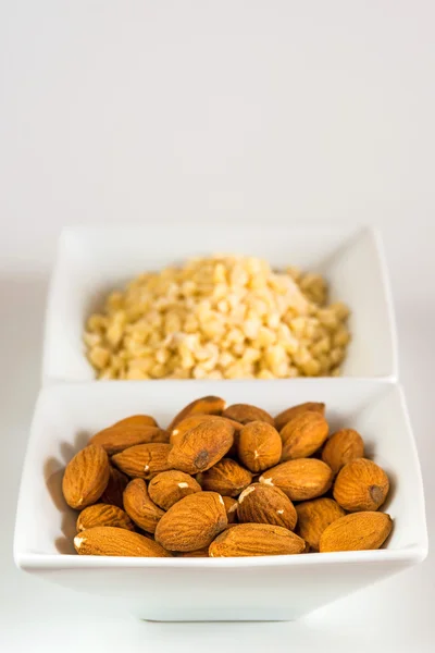 Almonds, whole and minced — Stock Photo, Image