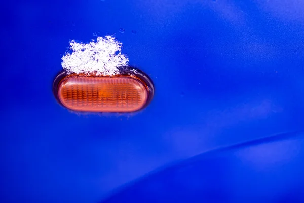 Snow on a car light — Stock Photo, Image