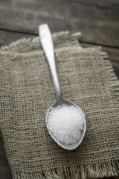 Coarse salt in a large old spoon — Stock Photo, Image