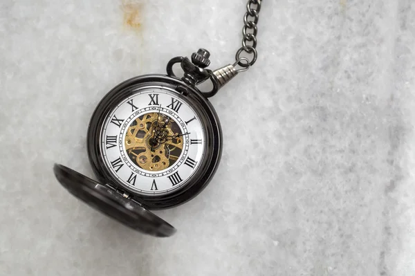 Pocket watch with  chain on marble. — Stock Photo, Image