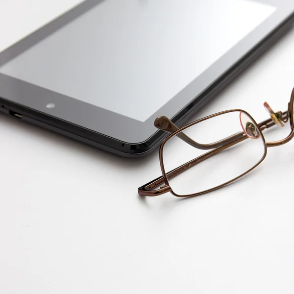 Tablet ordenador y gafas graduadas — Foto de Stock