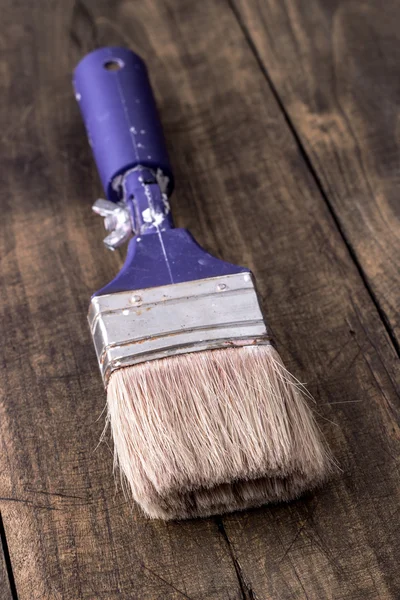 Paint brush on a wooden board — Stock Photo, Image