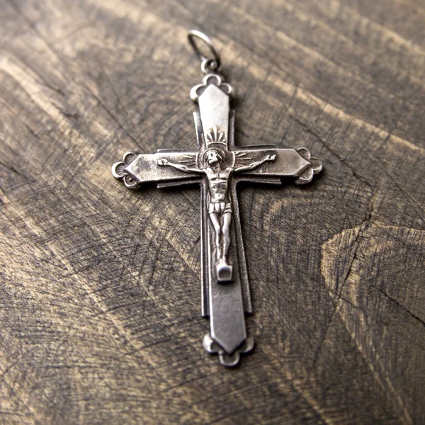 Metal cross lying on the table — Stock Photo, Image