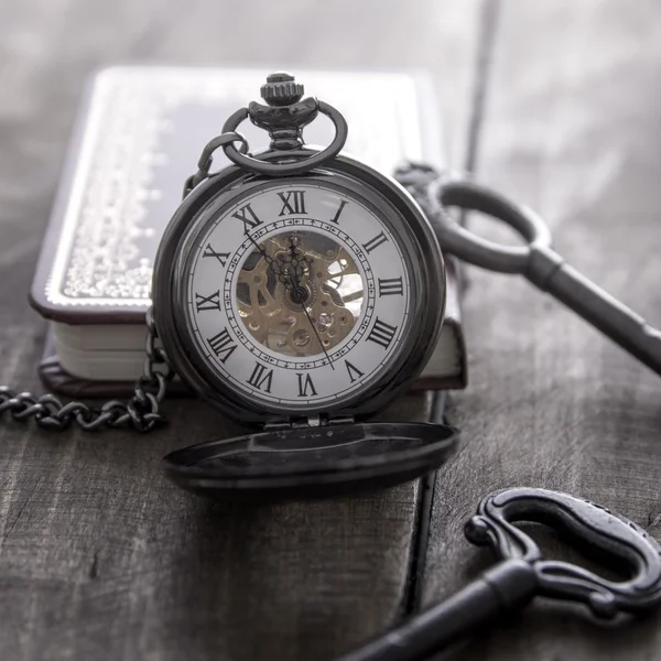 Pocket watch on grunge wooden table — Stock Photo, Image