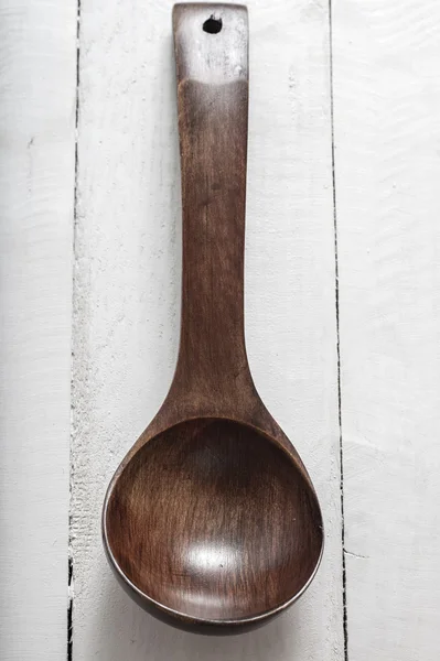 Wooden spoon over white wooden background — Stock Photo, Image