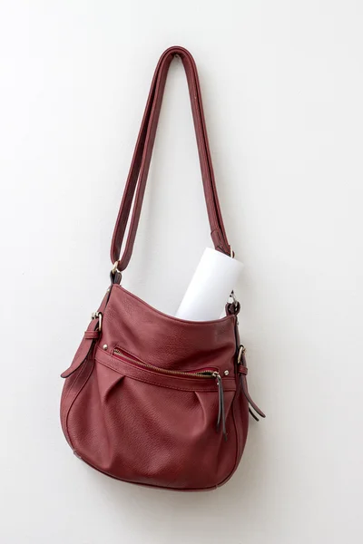Red bag hanging  over a white wall — Stock Photo, Image