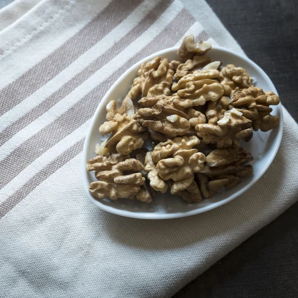Walnuts on rustic wooden table. — Stock Photo, Image