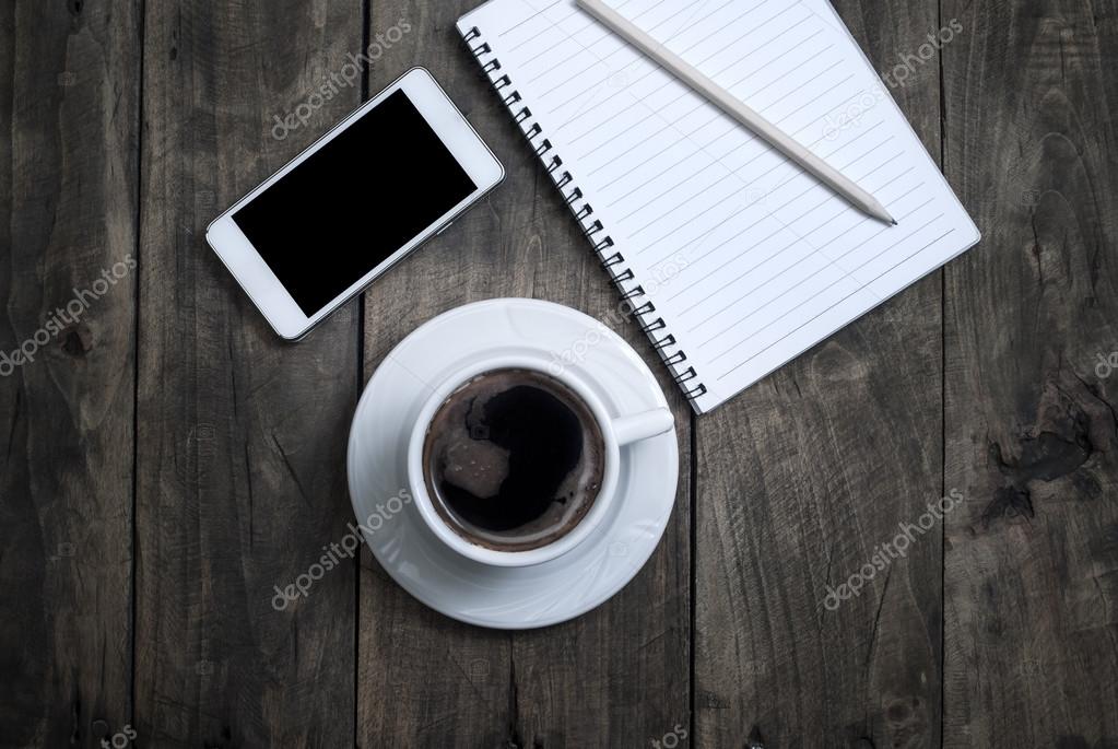 Black  blank screen on the phone and cup of coffee