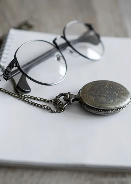 Old pocket watch and glasses — Stock Photo, Image