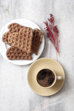heart shaped waffles and coffee on table