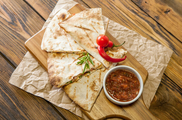 Tacos on wooden background with sauce