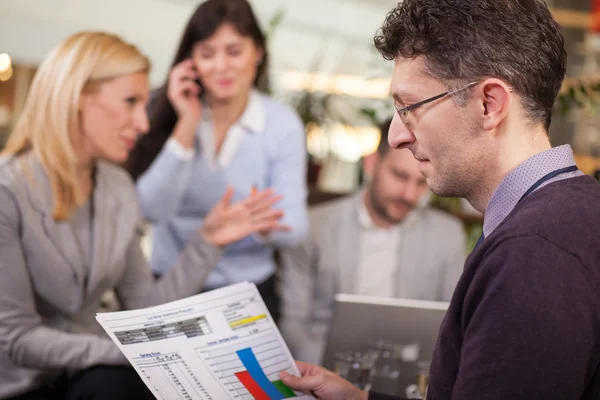 Business partners talking and working in coffee bar — Stock Photo, Image