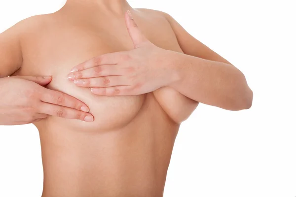 El cuerpo de la hembra examinando los senos. Aislado sobre blanco . Imagen De Stock
