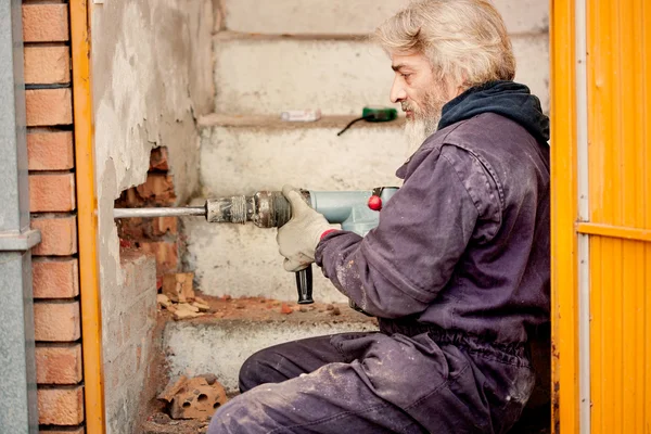 Builder worker with pneumatic hammer drill equipment breaking br — Stock Photo, Image