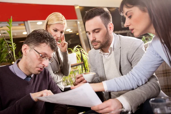 Group of business people  meeting in coffee shop and holding a b — Stock Photo, Image