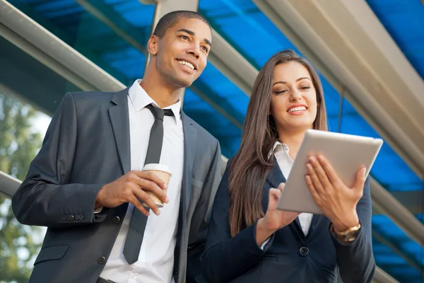 Young serious successful businesswoman with tablet computer talk — Stock Photo, Image