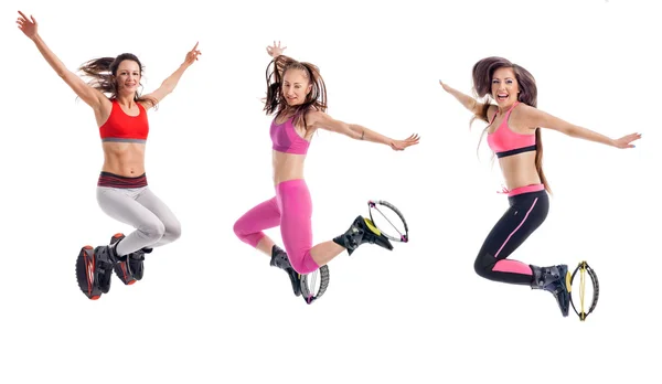 Three beautiful girls  jumping and exercising with kangoo shoes, — Stock Photo, Image