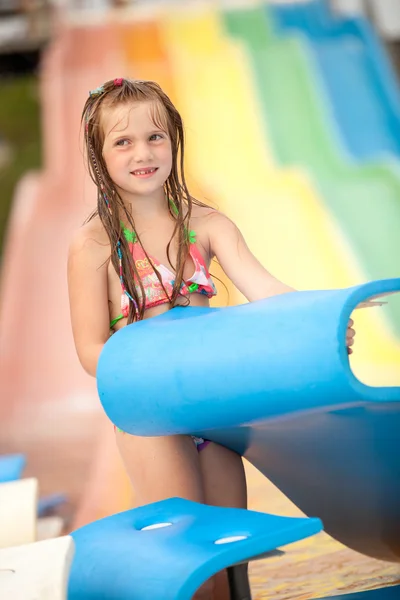 Funny excited child enjoying summer vacation in water park — Stock Photo, Image