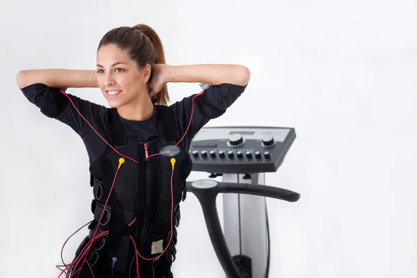 Young fit woman exercise on electro muscular stimulation machine — Stock Photo, Image