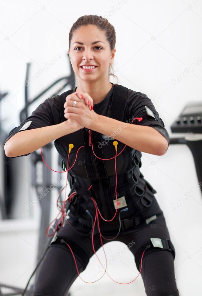 woman exercise key position  on  electro stimulation machine