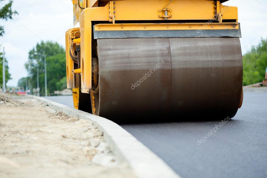 Orange road-roller on repairing of the road 