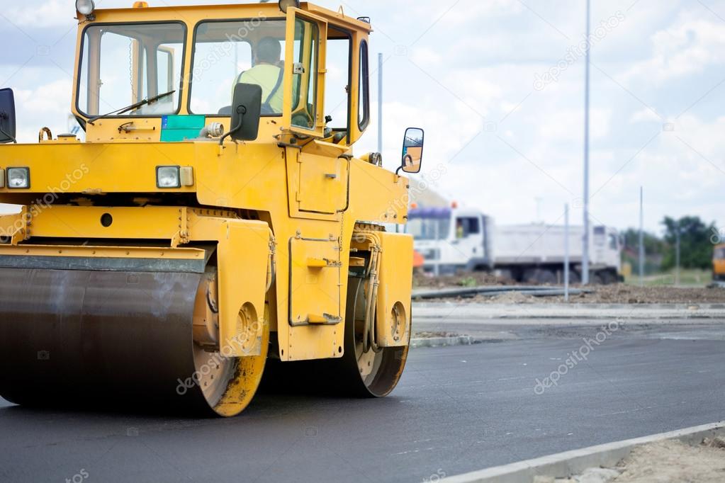 Orange road-roller on repairing of the road