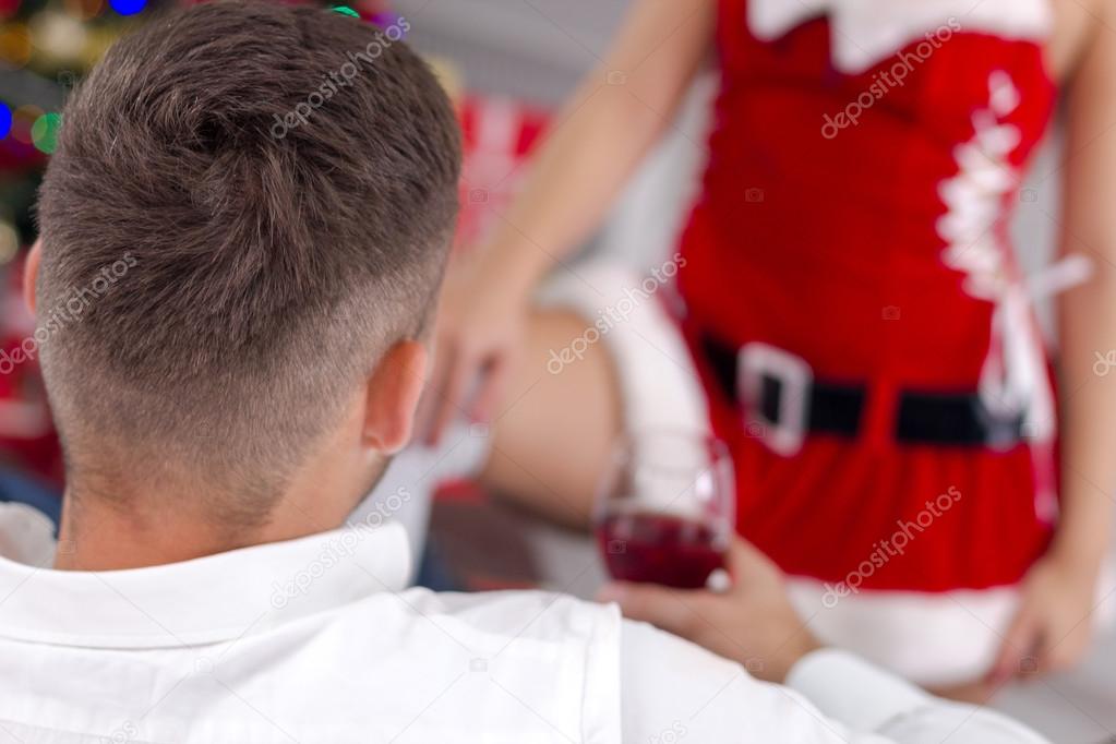 sexy female Santa seduces man on Christmas Eve