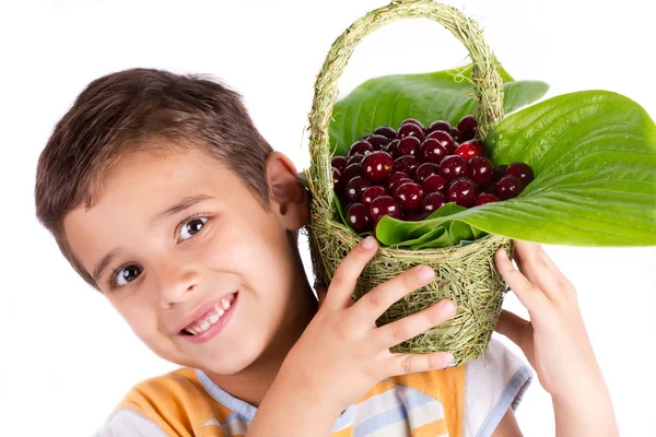 年轻快乐的男孩拿着樱桃的篮子 — 图库照片