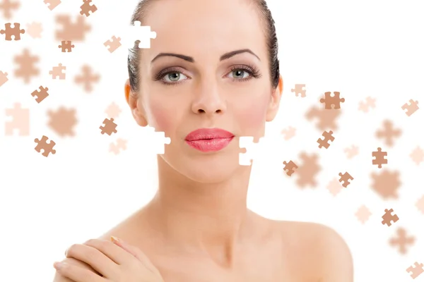 Face of beautiful young woman with a puzzle collage of her skin — Stock Photo, Image