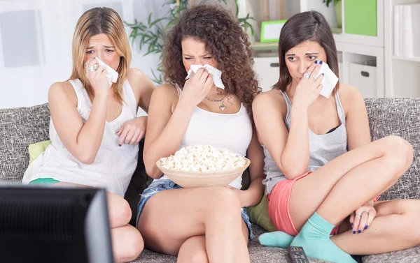 Frauen, die deprimiert auf der Couch sitzen und einen traurigen Film ansehen — Stockfoto