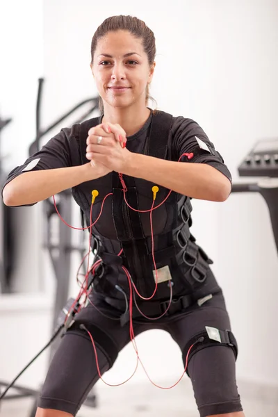 Fit woman exercise on electro muscular woman — Stock Photo, Image